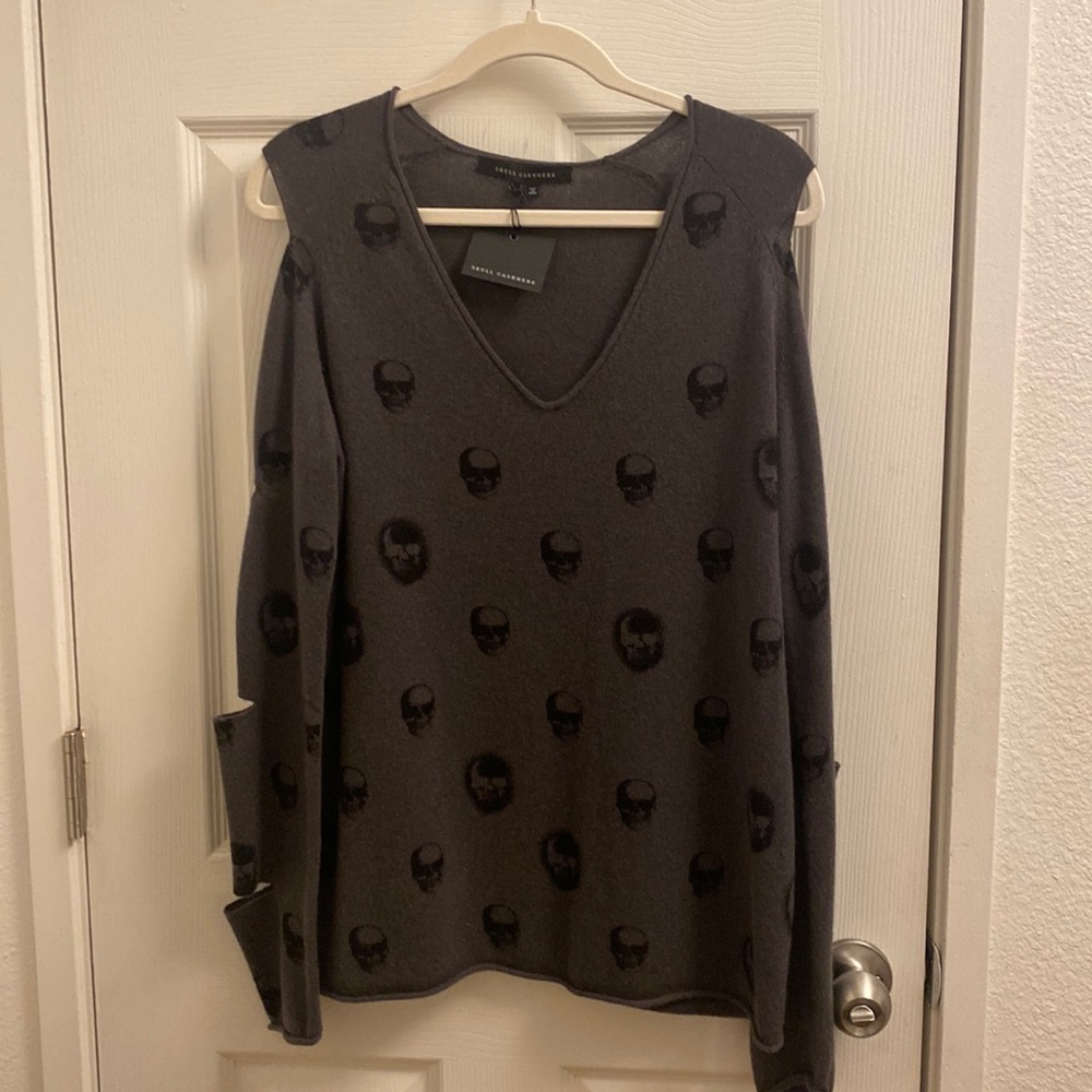 “Skull” Cashmere sweater with open spots down the sleeves.